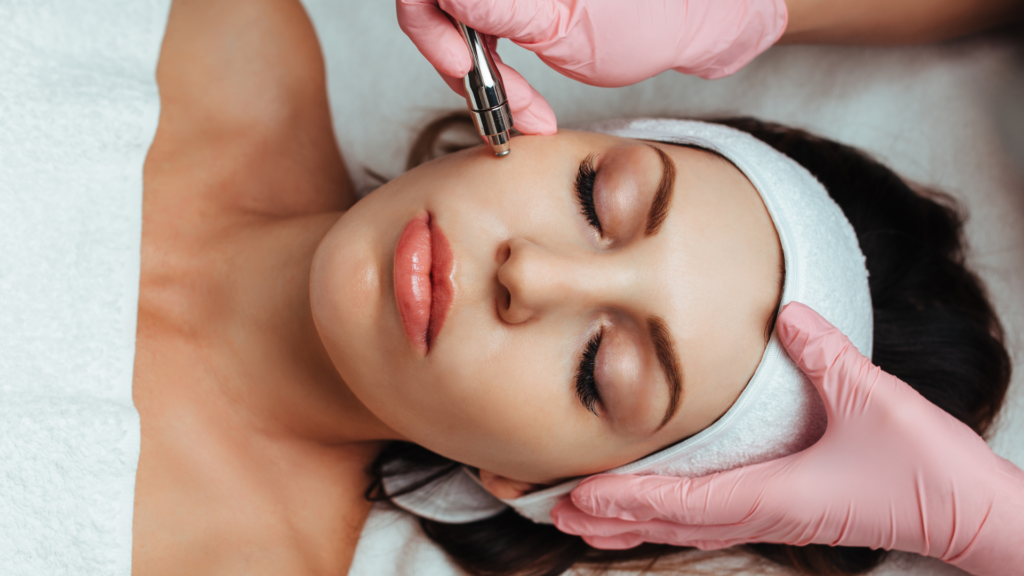 esthetician school in Dallas student wearing pink gloves applies skincare treatment to client