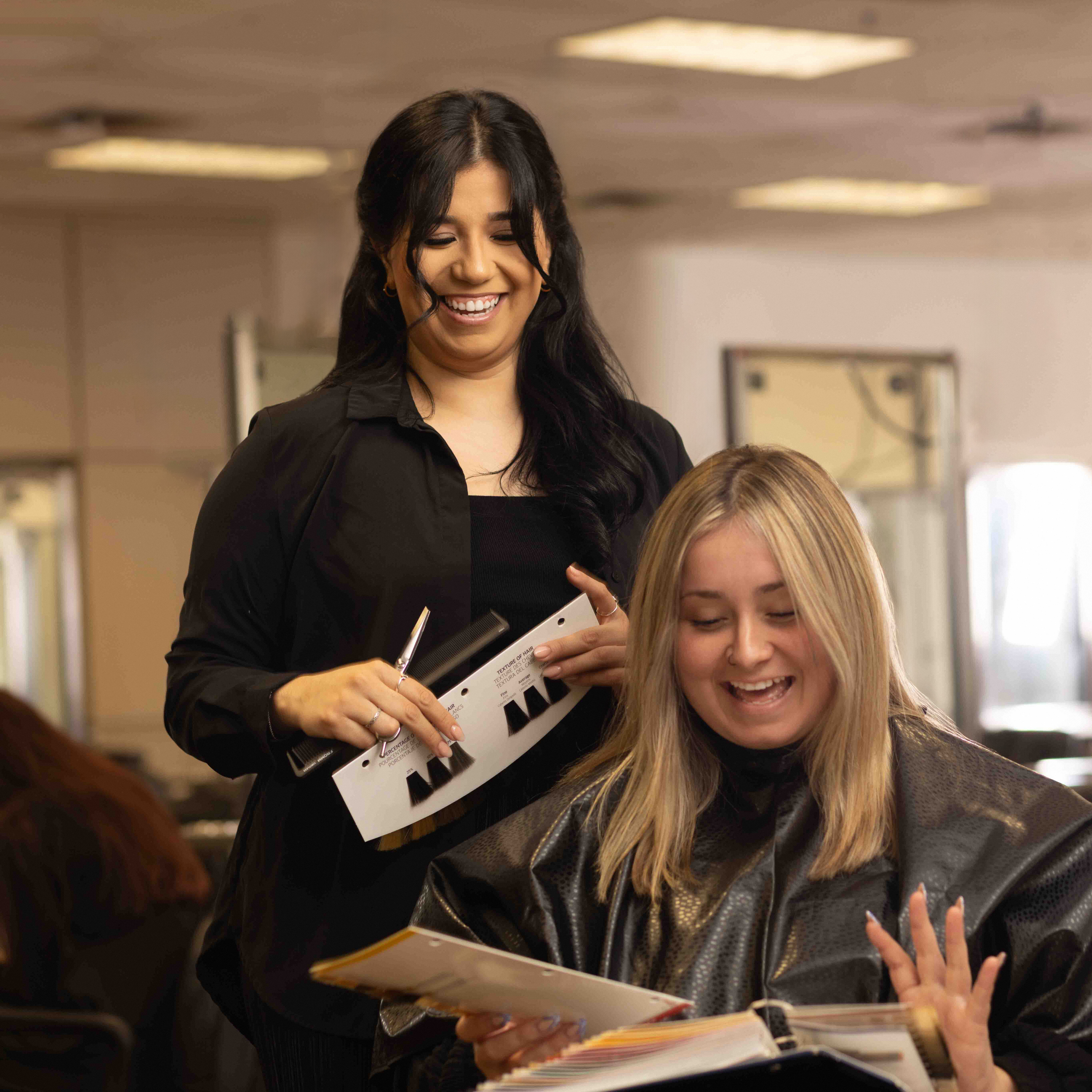 Cosmetology school student in a cosmetology training program applying hair color to a client
