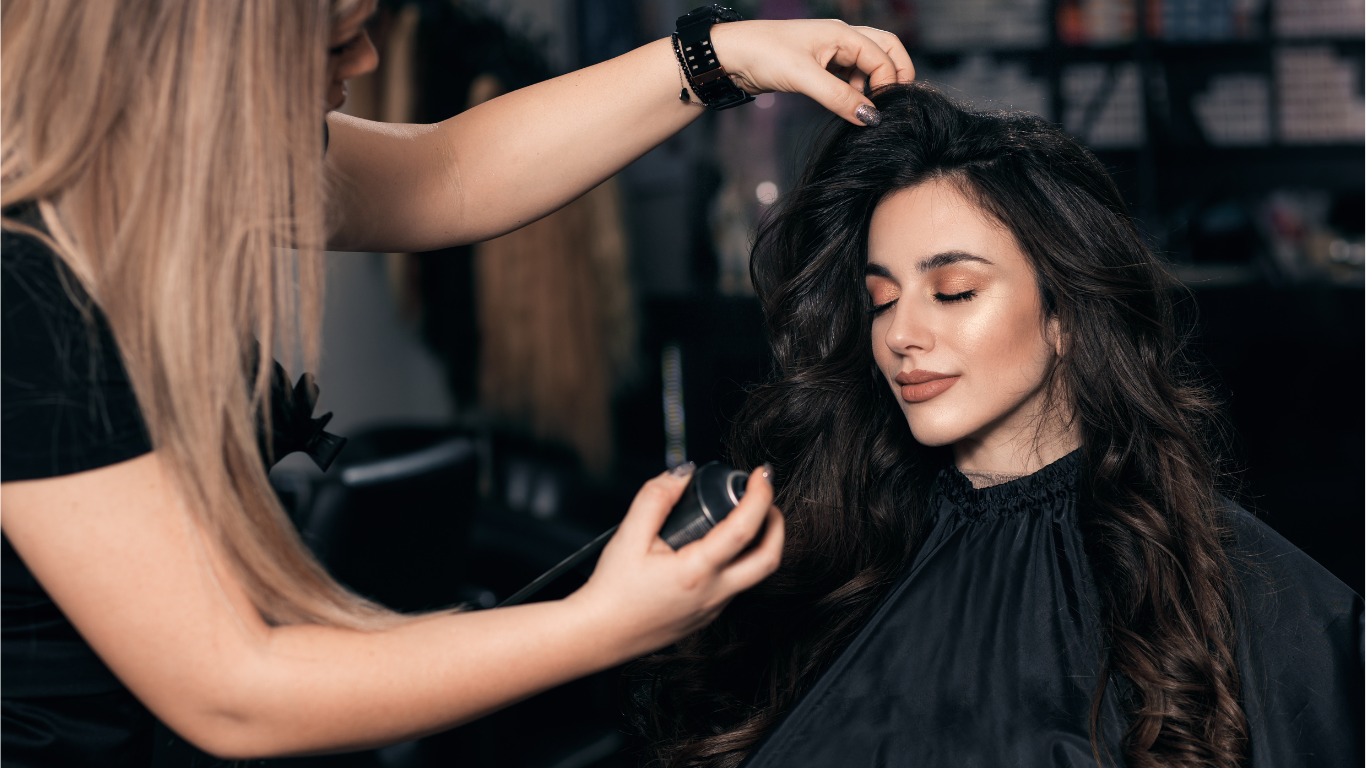 Image of a cosmetolgoy school student performing hair care services on a client