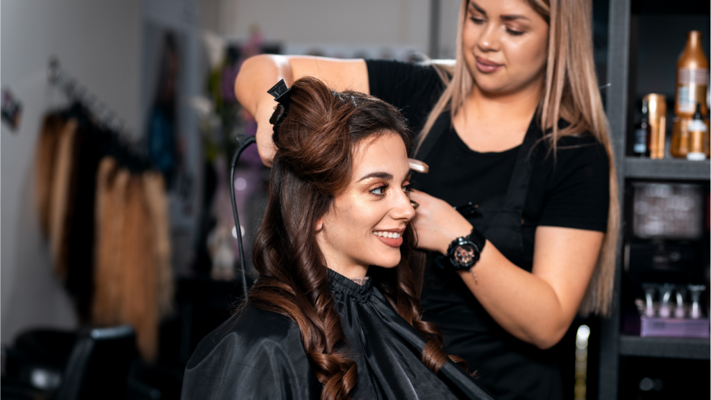 Image of a cosmetolgoy school student performing hair care services on a client